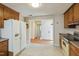 Functional kitchen featuring wood cabinets, laminate countertops, and access to other rooms at 2211 Hillock Dr, Raleigh, NC 27612
