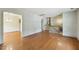Spacious living room showcasing hardwood floors, neutral walls, and stairs leading to the second floor at 2211 Hillock Dr, Raleigh, NC 27612