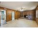 Spacious living room with brick fireplace and wood paneling on the walls at 2211 Hillock Dr, Raleigh, NC 27612