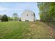 Large backyard with a partial fence and some wooded border at 226 Fair Oaks Ct, Mebane, NC 27302