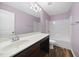 Well-lit bathroom with vanity, large mirror, and tub/shower combo at 226 Fair Oaks Ct, Mebane, NC 27302