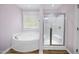 Bathroom featuring soaking tub and walk-in shower at 226 Fair Oaks Ct, Mebane, NC 27302