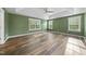 Spacious bedroom with tray ceilings, green walls, and hardwood floors at 226 Fair Oaks Ct, Mebane, NC 27302