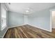Cozy bedroom has a ceiling fan, light walls, and hardwood floors at 226 Fair Oaks Ct, Mebane, NC 27302