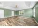 Bedroom features tray ceilings, green walls, and beautiful hardwood floors at 226 Fair Oaks Ct, Mebane, NC 27302