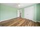 Bedroom features green walls, wood floors, and a ceiling fan at 226 Fair Oaks Ct, Mebane, NC 27302