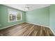 Bright bedroom with green walls, wood floors, and a ceiling fan at 226 Fair Oaks Ct, Mebane, NC 27302