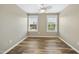 Bedroom showcasing hardwood floors, two windows providing natural light, and white trimwork at 226 Fair Oaks Ct, Mebane, NC 27302