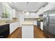 Kitchen featuring white cabinets, stainless steel appliances, granite countertops, and hardwood flooring at 226 Fair Oaks Ct, Mebane, NC 27302