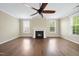 Living room with hardwood floors, a ceiling fan, a fireplace and ample natural light at 226 Fair Oaks Ct, Mebane, NC 27302
