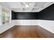 Spacious office boasts wainscoting, coffered ceiling, and sleek black accent wall at 226 Fair Oaks Ct, Mebane, NC 27302