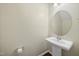 Simple powder room with pedestal sink, round mirror, and classic design at 226 Fair Oaks Ct, Mebane, NC 27302