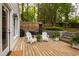 Backyard featuring a spacious wooden deck, outdoor seating, a grill and lush greenery in a serene setting at 2415 Van Dyke Ave, Raleigh, NC 27607