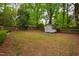 Backyard featuring a shed, wood fence, and mature trees at 2415 Van Dyke Ave, Raleigh, NC 27607