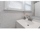 Bathroom boasts trendy wallpaper, a modern vanity, and a large mirror creating a chic and stylish space at 2415 Van Dyke Ave, Raleigh, NC 27607