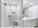 Bathroom featuring a glass-enclosed shower with subway tile and a built-in seat, plus a vanity with white cabinets at 2415 Van Dyke Ave, Raleigh, NC 27607