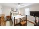 Bedroom features hardwood floors, a cozy bed, bedside tables and an abundance of natural light at 2415 Van Dyke Ave, Raleigh, NC 27607