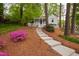 Charming home with a walkway, picket fence, and colorful flowers at 2415 Van Dyke Ave, Raleigh, NC 27607