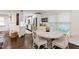 Bright kitchen and dining area with white cabinetry, stainless steel appliances, and hardwood floors at 2415 Van Dyke Ave, Raleigh, NC 27607