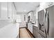 Modern kitchen featuring white countertops, stainless steel appliances, and stylish cabinetry at 2415 Van Dyke Ave, Raleigh, NC 27607