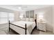 Comfortable bedroom featuring a king bed, neutral decor, ceiling fan and natural light from the large window at 2415 Van Dyke Ave, Raleigh, NC 27607
