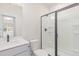 Modern bathroom featuring a black-framed glass shower, white vanity, and toilet at 2434 Heron Watch Pl, Fuquay Varina, NC 27526