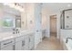 Bathroom featuring double vanity, separate shower, and soaking tub at 2434 Heron Watch Pl, Fuquay Varina, NC 27526