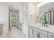 Bathroom featuring a double vanity, tiled floors, walk-in shower, and separate toilet room at 2434 Heron Watch Pl, Fuquay Varina, NC 27526