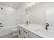 Bright bathroom with double sinks, quartz counters, and a tub shower combo at 2434 Heron Watch Pl, Fuquay Varina, NC 27526