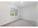 Cozy bedroom featuring neutral walls, plush carpeting, and a window with floral patterned shades at 2434 Heron Watch Pl, Fuquay Varina, NC 27526