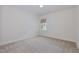 Bedroom with carpeted floors, neutral walls and a window with patterned shade at 2434 Heron Watch Pl, Fuquay Varina, NC 27526