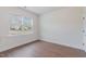 Bedroom with window letting in natural light, hardwood floor, with neutral colored walls at 2434 Heron Watch Pl, Fuquay Varina, NC 27526
