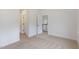 Bright bedroom features neutral carpet and an open doorway to the upper level at 2434 Heron Watch Pl, Fuquay Varina, NC 27526