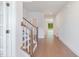 Bright hallway with hardwood floors, stairs, and natural light at 2434 Heron Watch Pl, Fuquay Varina, NC 27526