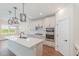 Modern kitchen featuring stainless steel appliances, a central island, and stylish pendant lighting at 2434 Heron Watch Pl, Fuquay Varina, NC 27526