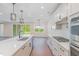 Bright and airy kitchen with stainless steel appliances, island, and hardwood flooring at 2434 Heron Watch Pl, Fuquay Varina, NC 27526