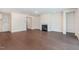 Spacious living room with a cozy fireplace, hardwood floors, and plenty of natural light at 2434 Heron Watch Pl, Fuquay Varina, NC 27526