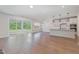 Open-concept living space with hardwood floors and large sliding glass doors to outdoor area at 2434 Heron Watch Pl, Fuquay Varina, NC 27526