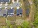 Aerial shot of backyard featuring a patio set, pond, and privacy fence at 261 Emory Bluffs Dr, Holly Springs, NC 27540