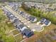Aerial view of a neighborhood showcasing well-maintained homes and manicured lawns at 261 Emory Bluffs Dr, Holly Springs, NC 27540