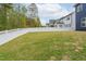Expansive backyard with lush green grass and a white picket fence, perfect for outdoor activities at 261 Emory Bluffs Dr, Holly Springs, NC 27540