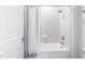 Bright bathroom featuring a modern shower with white subway tile and gray accents at 261 Emory Bluffs Dr, Holly Springs, NC 27540