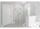 Elegant bathroom with glass-enclosed shower, white marble accents, and a clean, modern design at 261 Emory Bluffs Dr, Holly Springs, NC 27540
