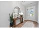 Bright entryway with wood floors, white trim, a console table, and a front door with sidelights at 261 Emory Bluffs Dr, Holly Springs, NC 27540