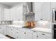 Bright kitchen with white cabinets, stainless steel appliances, and stylish backsplash at 261 Emory Bluffs Dr, Holly Springs, NC 27540