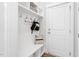 Organized mudroom with hooks and shelves for easy storage, adjacent to the front door at 261 Emory Bluffs Dr, Holly Springs, NC 27540