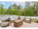 Inviting patio area furnished with stylish outdoor seating, perfect for enjoying the backyard view at 261 Emory Bluffs Dr, Holly Springs, NC 27540