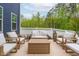 Cozy patio with comfortable seating, ideal for outdoor entertaining and relaxation at 261 Emory Bluffs Dr, Holly Springs, NC 27540