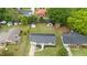 Aerial view of the home with metal roof, surrounding neighborhood, green lawns, and mature trees at 2712 Cameron Dr, Sanford, NC 27332