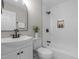 Bathroom with white subway tile, decorative niche, modern fixtures, and curved mirror at 2712 Cameron Dr, Sanford, NC 27332